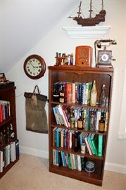 Bookcase with books, Bakelite radio (as is), pipes, old telephone