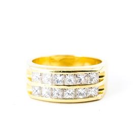 18K Yellow Gold and Diamond Ring: An 18k yellow gold and diamond ring. It features two lines of diamonds set on a gold band.