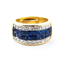 18K Yellow Gold, Blue Sapphire, and Diamond Ring: An 18k yellow gold, blue sapphire, and diamond ring. It features two strips of blue sapphires flanked by diamond bands.