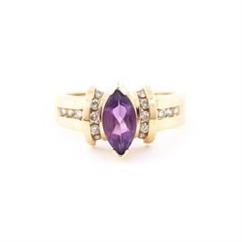 14K Yellow Gold, Amethyst, and Diamond Ring: A 14k yellow gold, amethyst, and diamond ring. It features a marquise faceted purple amethyst beset by bands of diamonds, with lines of diamonds cascading down the sides of a golden band.