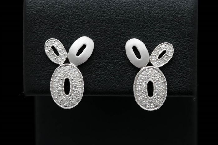 0.25 CTW Diamond and 14K White Gold Earrings: A pair of 0.25 ctw diamond and 14K white gold earrings.
