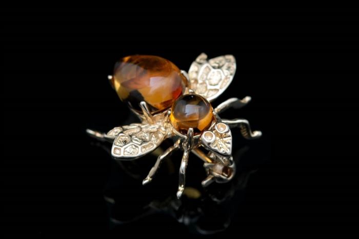 14K Yellow Gold and Citrine Wasp Pin: A 14K yellow gold and citrine wasp pin. The wasp pin features a citrine head and body with wings impressed with a honeycomb pattern.