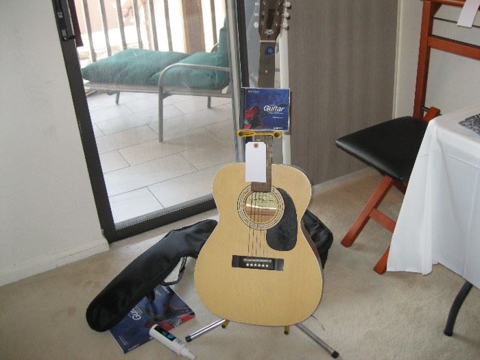 Guitar with case and accessories. 