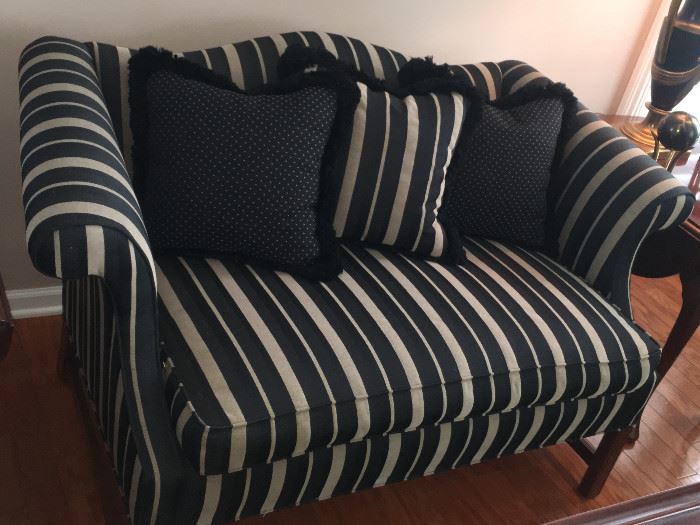 Custom striped mini sofa with exposed wood leg and camel back