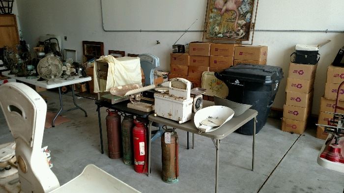 Vintage fire extinguishers and boxes full of books and magazines