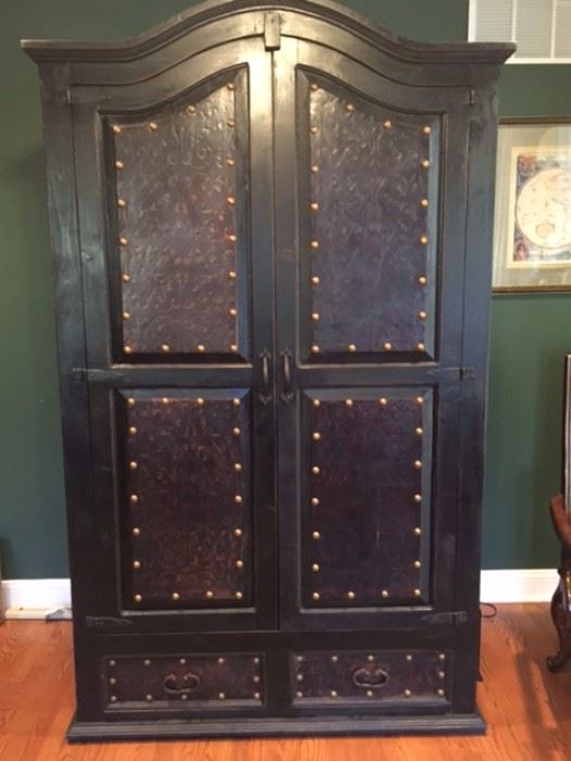 Armoire - Wood with leather faces with nailhead trim. 84 inches tall, 48 inches wide, 29 inches deep.