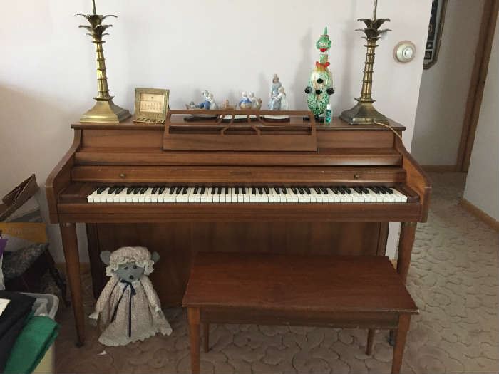 Whitney spinet piano with bench and sheet music