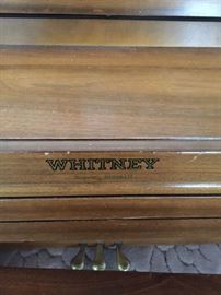 Whitney spinet piano with bench and sheet music