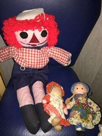 Raggedy Ann and Andy with their dolls on a vintage office chair
