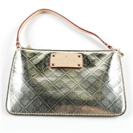 Kate Spade Purse: A Kate Spade purse. The handbag is made of patent leather and features a spade deco pattern throughout the entirety of the bag with a beige leather shoulder strap. The front of the handbag features a Kate Spade emblem as well as to the interior.