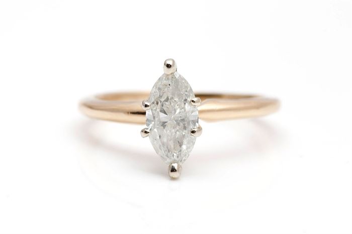 14K Yellow Gold 0.90 CT Diamond Solitaire Ring: A multi-faceted marquise cut diamond solitaire held by six prongs on a yellow gold shank.
