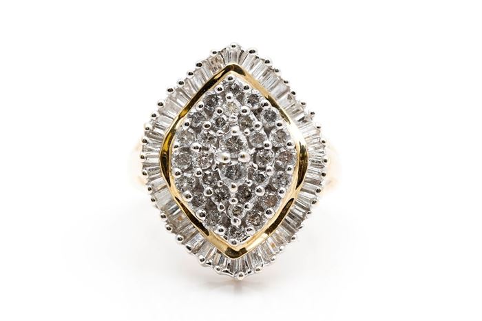 10K Yellow Gold 1.80 CT Diamond Ring: A yellow gold shank holds a marquise shaped mount to the center clustered with shared prong round cut diamonds and a halo of prong set baguettes.