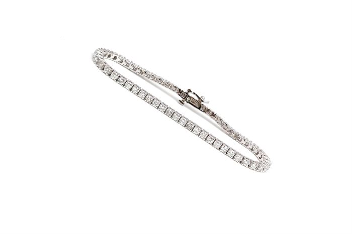 14K White Gold 4.33 CTW Diamond Bracelet: A white gold bracelet comprised of round cu basket prong set diamonds. The bracelet is in excellent condition and has never been worn.