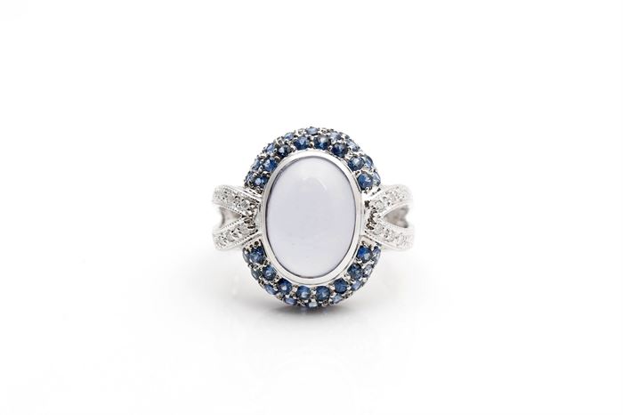 14K White Gold Chalcedony, Sapphire, and Diamond Ring:  white gold diamond-accented split shank with a bezel set oval chalcedony to the center and a halo of round cut sapphires.