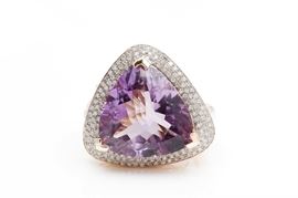 14K Yellow Gold Amethyst and Diamond Ring: A large multi-faceted amethyst is V-prong set to the center of a halo of pave’ set diamonds on a diamond accented yellow gold split shank.