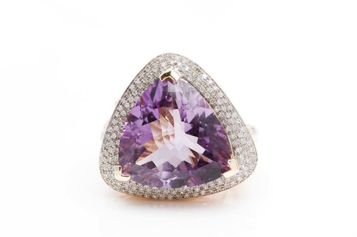 14K Yellow Gold Amethyst and Diamond Ring: A large multi-faceted amethyst is V-prong set to the center of a halo of pave’ set diamonds on a diamond accented yellow gold split shank.