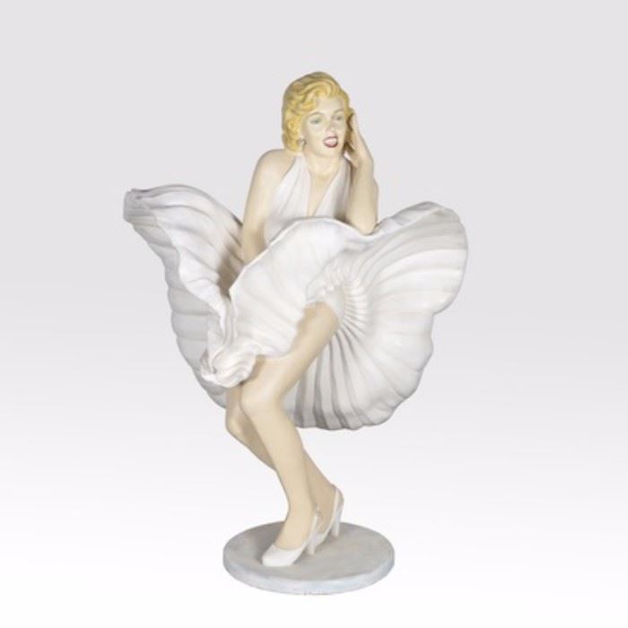 Life Size Marilyn Monroe Statue: A life-size Marilyn Monroe statue. This piece depicts Marilyn in the famous scene from The Seven Year Itch where her dress billows as she stands over a sidewalk grate as a subway train passes below. The statue is fashioned of plaster with a painted finish including her red hot lips and iconic mole. The piece rests on a round base.