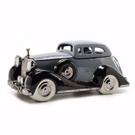 Glenn Appleman Limited Edition Rolls Royce Sculpture: A limited edition Rolls Royce sculpture by Glenn Appleman. This ceramic piece depicts a grey and black Rolls Royce with gold tone hood ornament. The roof of the car is removable. This piece is signed to the underside and dated “1983.” This piece includes a Certificate of Authenticity and is numbered “420/1000.”