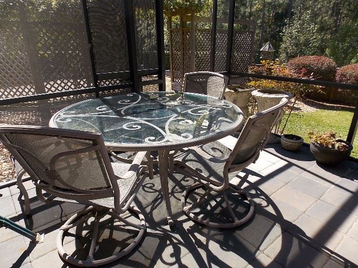 Patio glass top/metal table and chairs w/ ottomans
