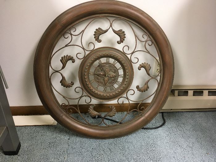 This is a great wall hanging that has a small clock in the center.