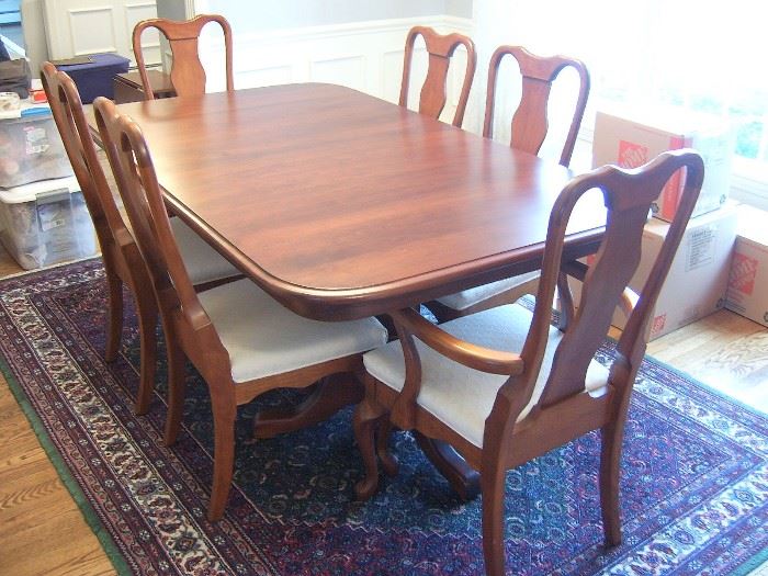 Amish built solid cherry dining table with six leaves and six chairs.