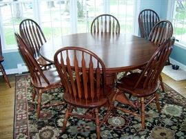 Amish built oak round pedestal table and eight Windsor style chairs.