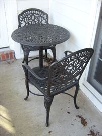 One set of three quality cast iron round tables and two cast iron chairs for each table.  (three tables and 6 chairs)