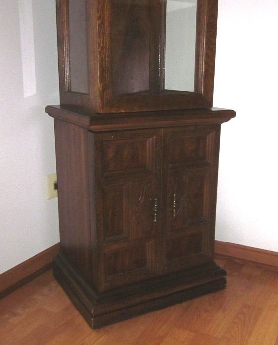 Wood curio cabinet, lighted, with glass door, sides and shelves, brass hardware and enclosed bottom storage area.  68" tall, 18" wide, 14" deep.