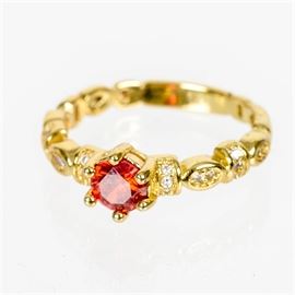 Gold-Plated Ring With Spessartite Garnet and Cubic Zirconia: A gold-plated ring with spessartite garnet and cubic zirconia.