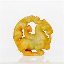 Serpentine Dragon Figurine: A serpentine dragon figurine. This figurine is made of a serpentine mineral. It is carved into a dragon-like figure being ridden by a smaller mouse-like figure.