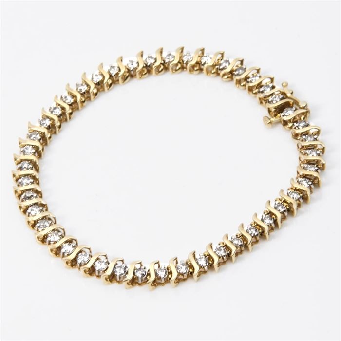 10K Gold and Diamond Tennis Bracelet: A 10K yellow gold and diamond tennis bracelet.