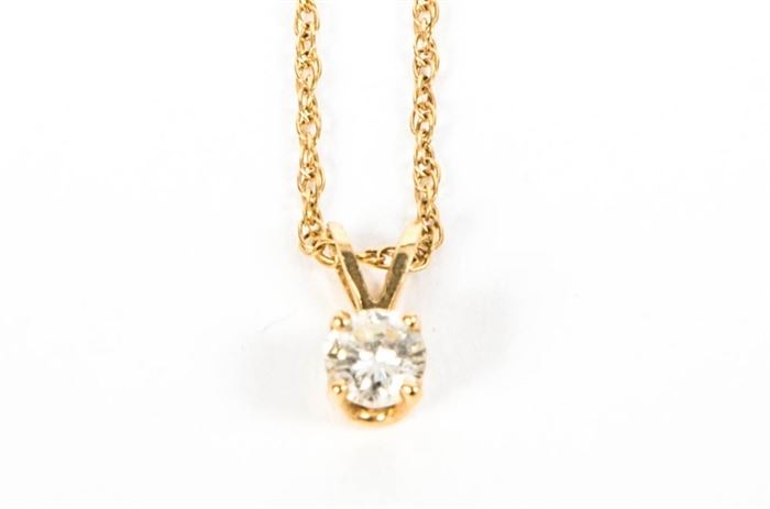 14K Yellow Gold and Diamond Necklace: A 14K yellow gold necklace with a diamond pendant.