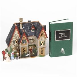 Department 56 "Literary Classics" Figurine and Book: A Department 56 “Literary Classics” figurine and book. The pair includes a hand-painted porcelain figurine of an English home, people figurines and the original lights. The figurine is dated 1998, and is marked to the underside “Dickens’ Village Series – Great Expectations ‘Satis Manor’”. Also included is a hardcover copy of Charles Dickens’ Great Expectations, published by Literary Classics Department 56.