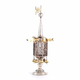 19th Century Russian Silver Spice Tower: A 19th century Russian sterling silver (stamped 84, tested to be 92.5 sterling) six sided spice tower with intricate filigree panels, flag pendants and dangling bells. The gold washed silver pendant finial at the top of the tapered spire is stamped “I.Pearlman, 84” with the double headed eagle hallmark and the base is stamped “I.P. 84” with the eagle hallmark as well. The filigree spice compartment has a hinged door, it is hung with bells over a turned support and domed circular base. The total approximate weight inclusive of all non-metal materials is 4.83 ozt.

According to rabbinic legend, each Jewish person receives a special soul (neshama yetera) on the Sabbath. As this extra spiritual dimension departs from the body at the close of the Sabbath, one is overcome with a certain degree of sorrow. The spices are interpreted as a means of comfort at the moment of transition to the new week. As it was customary in ancient times to welcome the Sab