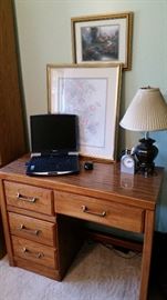 Nice desk with laptop, pictures, lamp