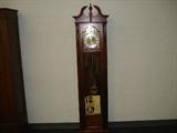 1987 Howard Miller Grandfather clock. "The Laketon" in cherry finish. 1/4 hour strike. Chain drive. Has on/off chime switch. In running condition.