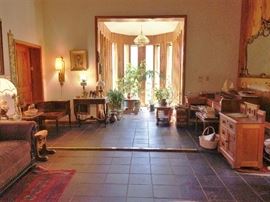 corner table, oak chest , oil lamp, music sheets and books, sofa , large mirror