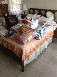 Bedding, linens, end tables, dresser with mirror, chest of drawers. 
