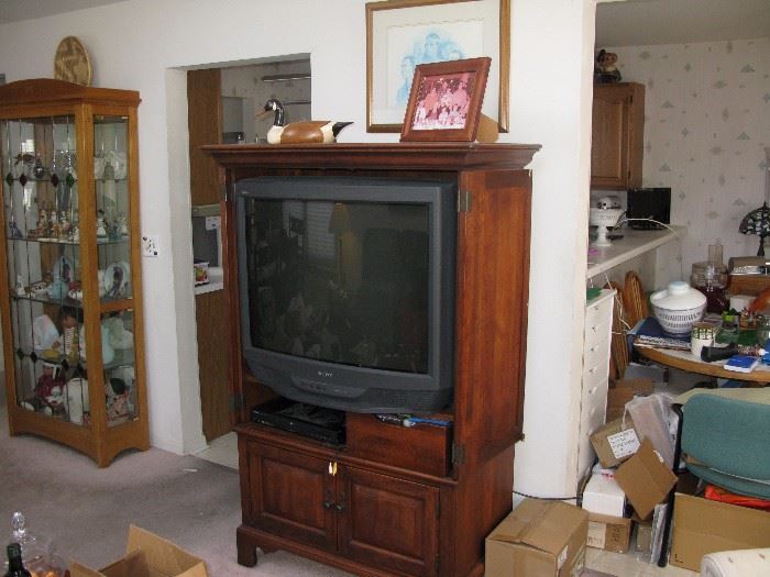 TV and cabinet. Very nice tall curio cabinet