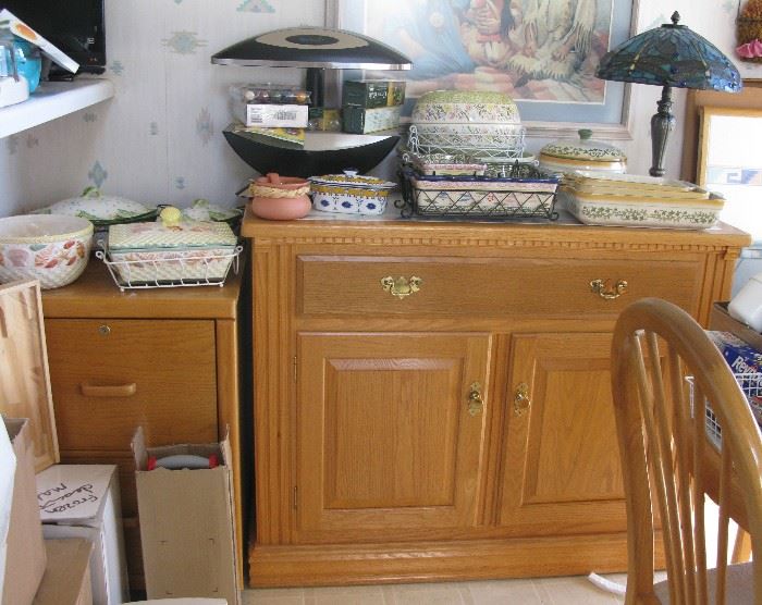 oak file cabinet and small size buffet. Tiffany style lamp, serving dishes and a seed grower to start your summer garden