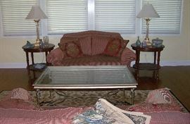 Partial view of the living room - large brass and glass top coffee table - pair of love seats