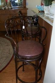 One of a pair of iron bar stools