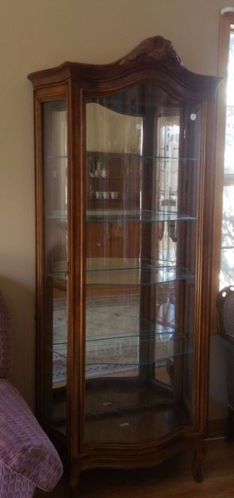 Lighted china cabinet with bow-front glass