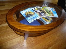 OVAL TWO TIER COFFEE TABLE WITH BEVELED GLASS INLAY TOP AND LEGS&nbsp;CAPPED WITH BRASS