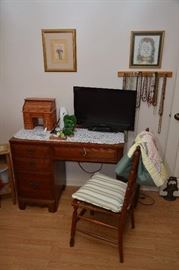 Davis desk, single chair, TV, roll-top desk jewelry box, assorted necklaces, artwork