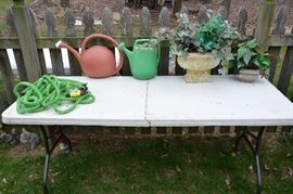 watering cans, hose, artificial plants