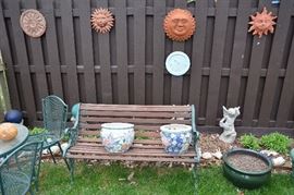 bench, planters, sun and star wall plaques, statuary