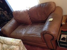 #89 Brown leather love seat w nail head front 68 long as is $300 