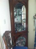 Lighted, beveled glass corner cabinet