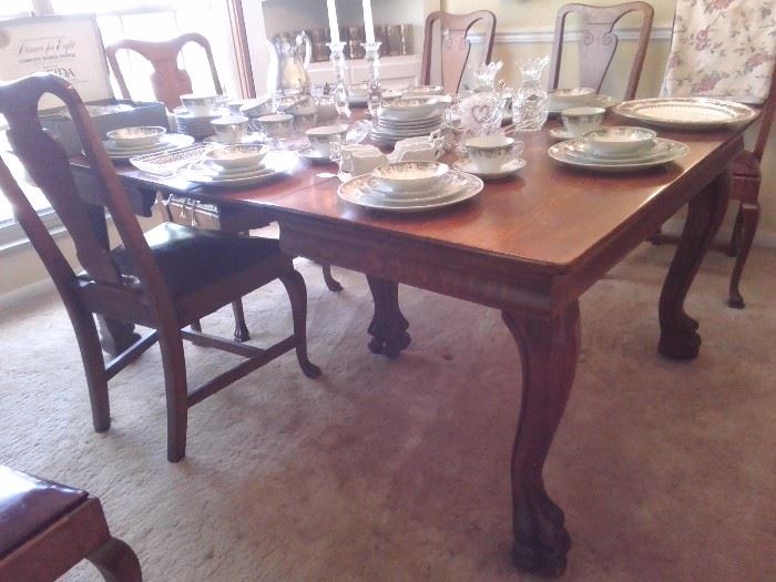 Solid oak antique table with ball and claw feet. Table is 48 X 48 with 4 9" leaves. Comes with 6 solid oak chairs with ball and claw front feet.